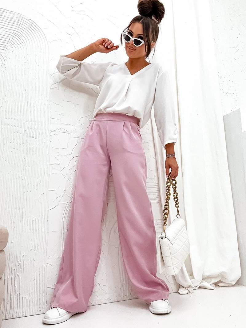 Szerokie pudrowo-różowe materiałowe spodnie damskie